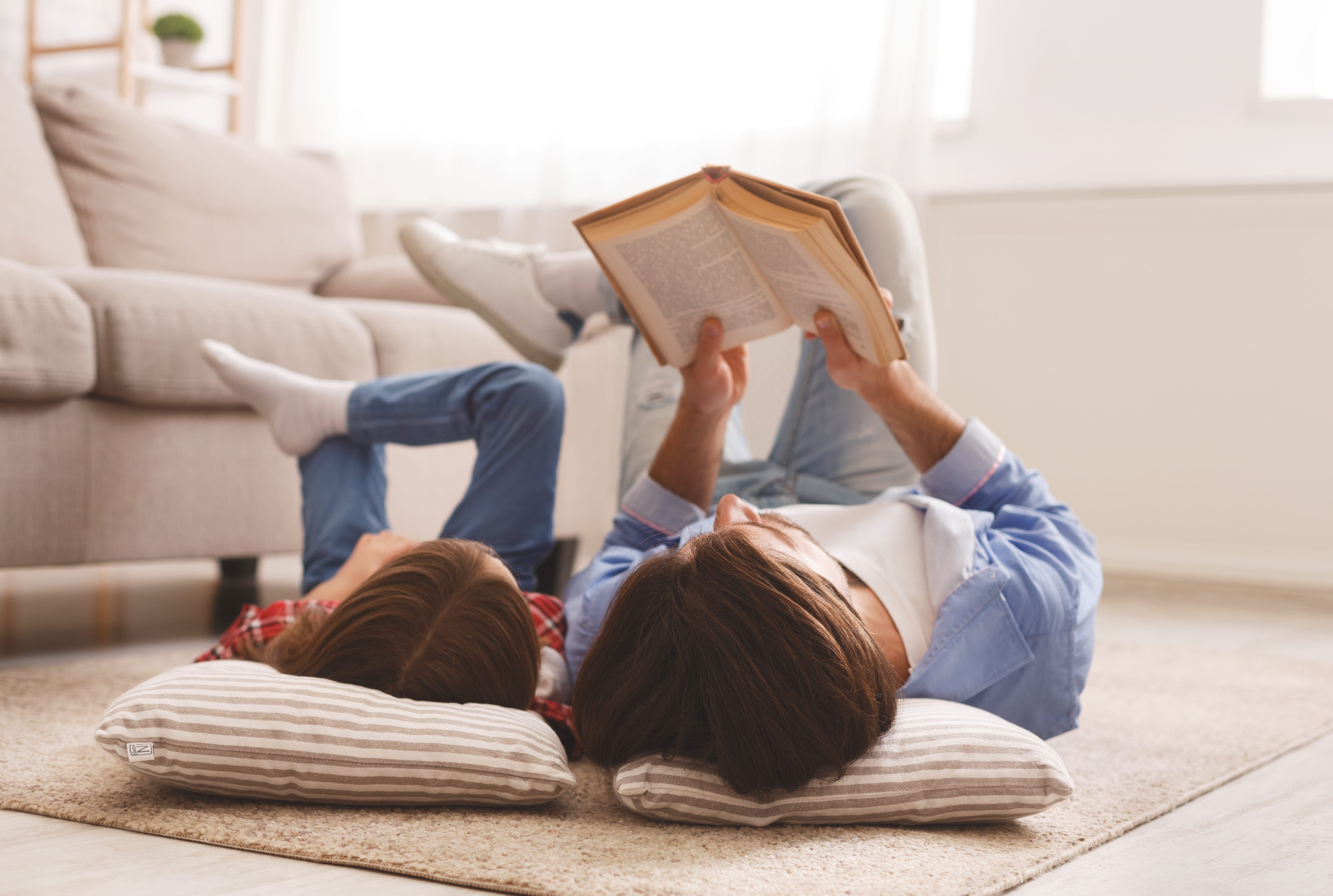 woman and child reading book together