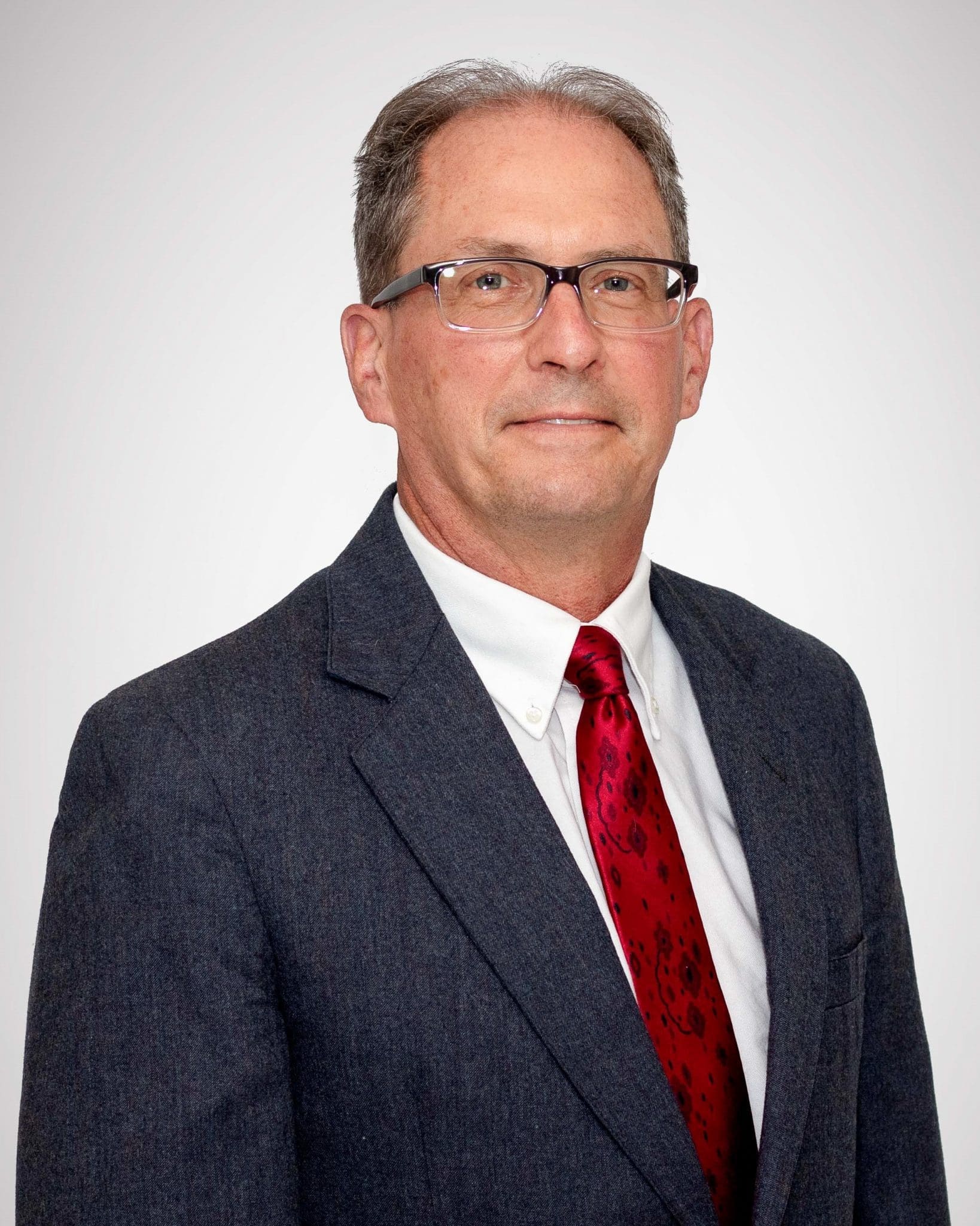 man in suit and red tie headshot, located at Virginia Gay Hospital