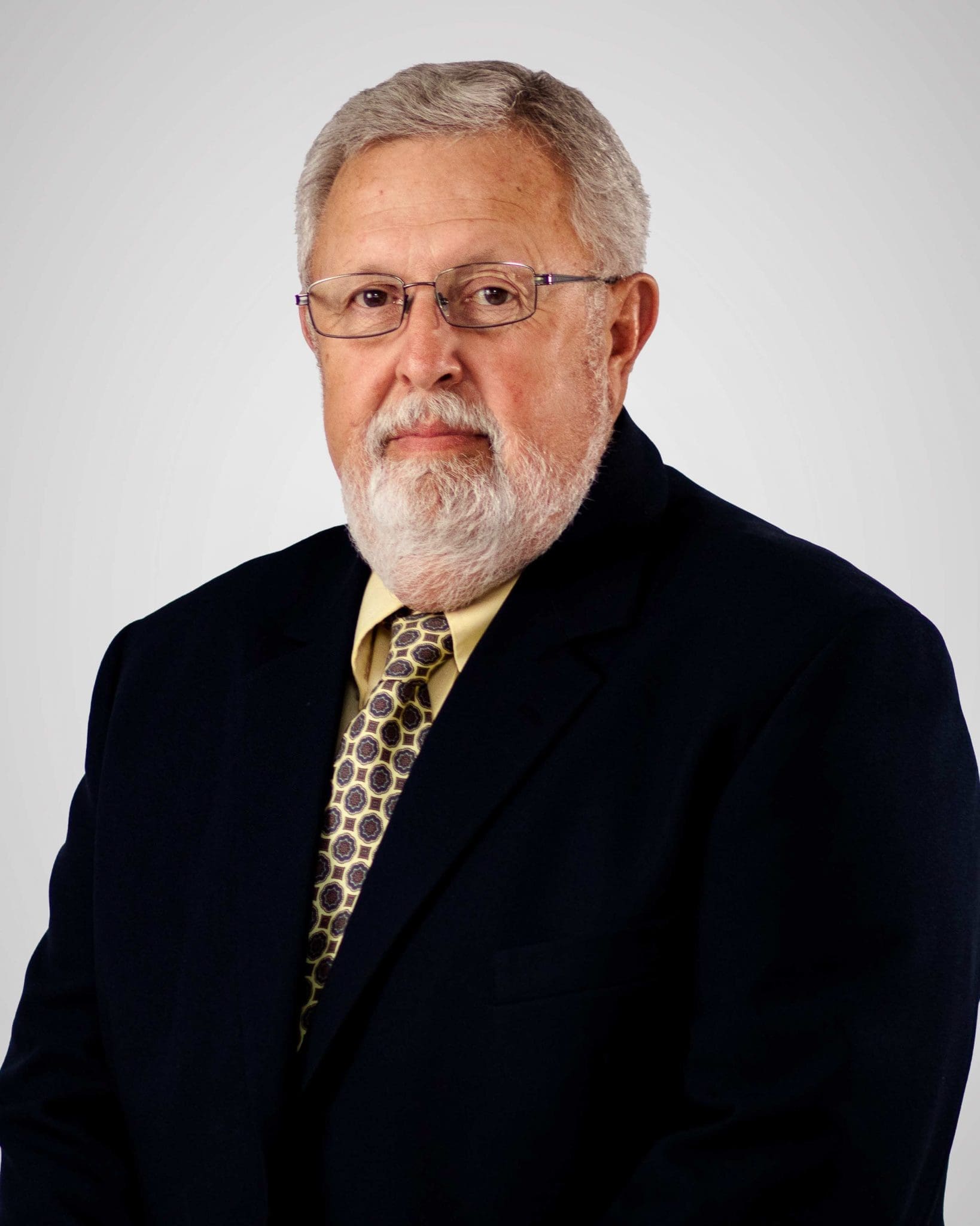 Man in suite and yellow tie headshot, located at Virginia Gay Hospital