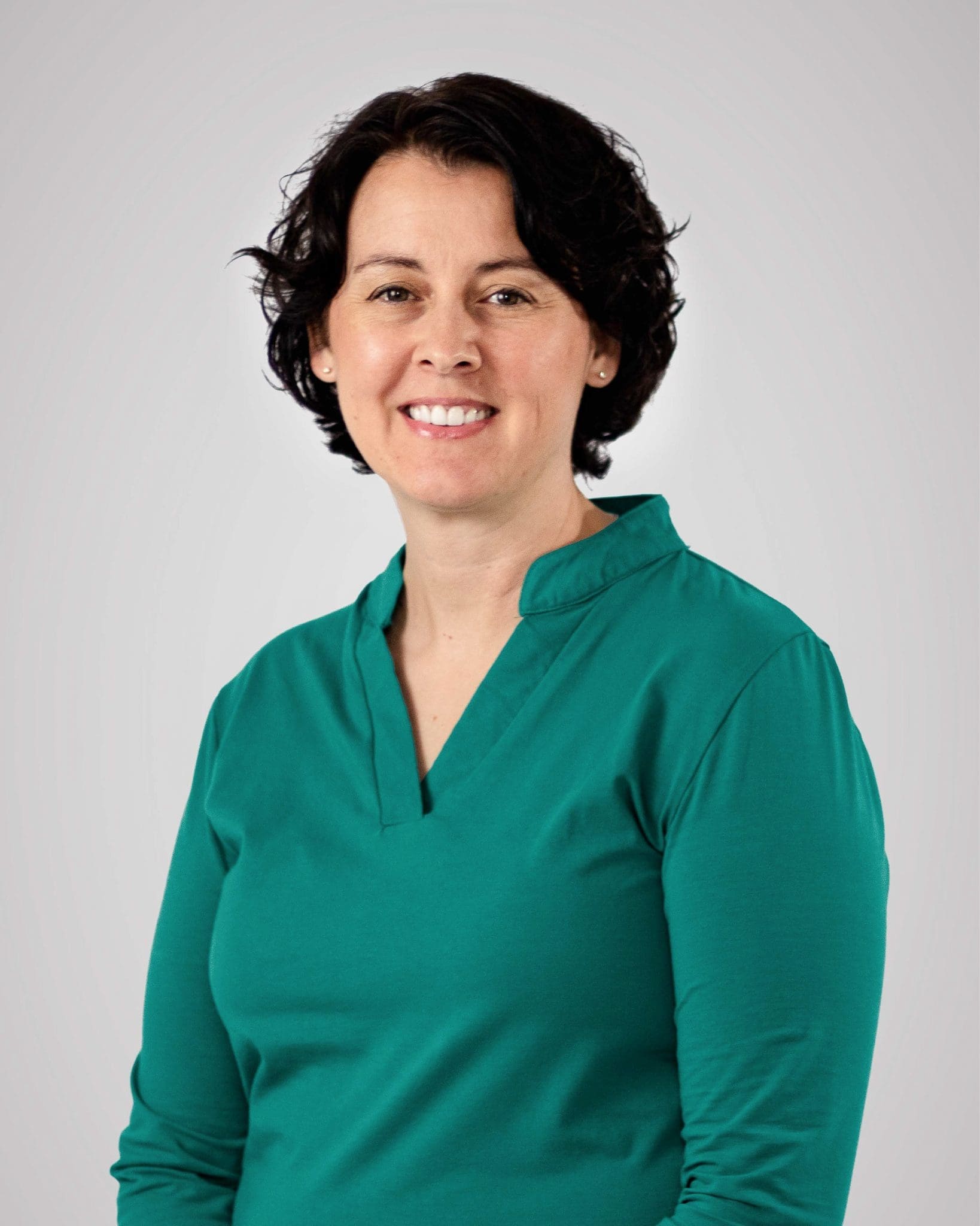 dark haired female in green shirt headshot, located at Virginia Gay Hospital