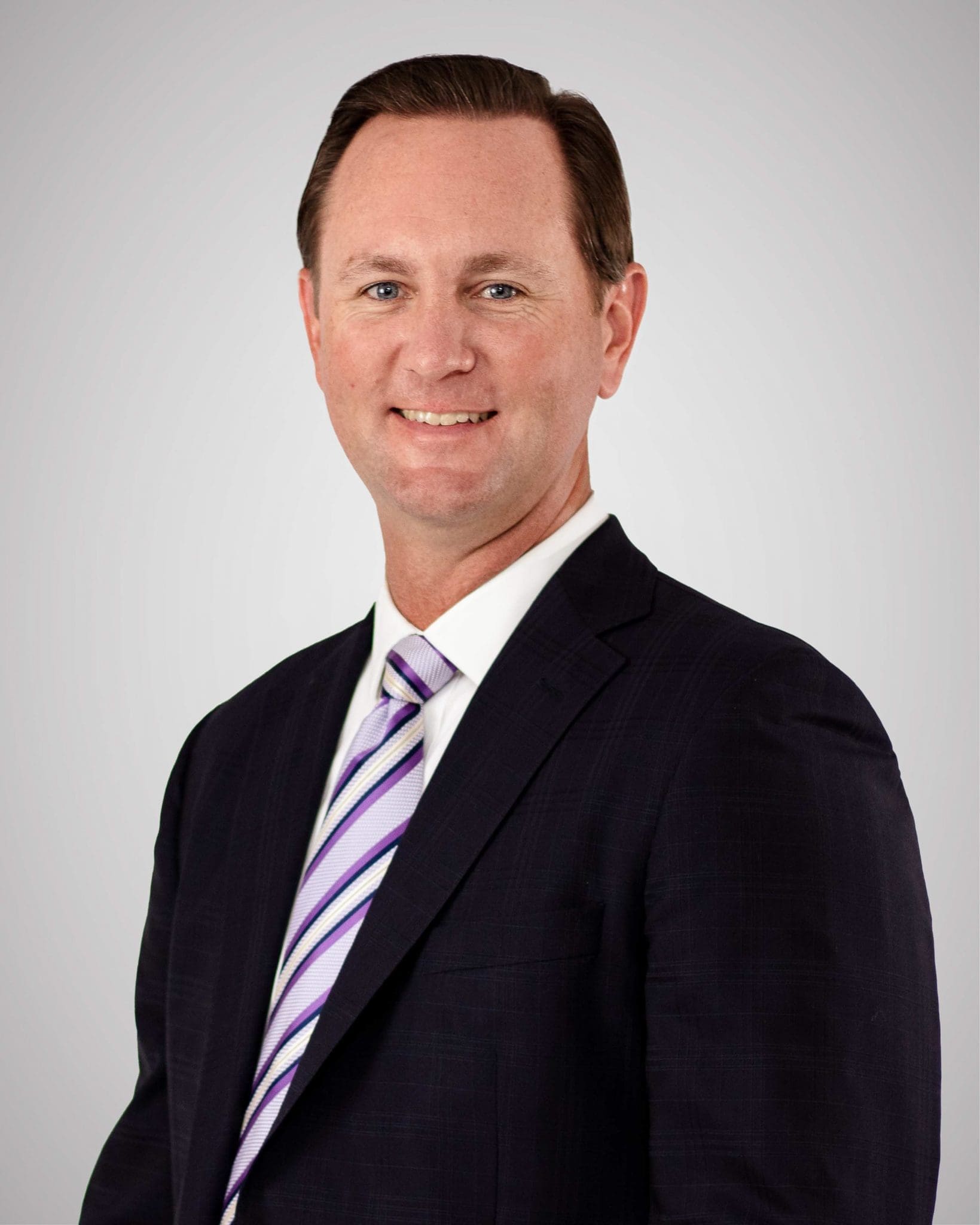 man in suite with purple tie headshot, located at Virginia Gay Hospital