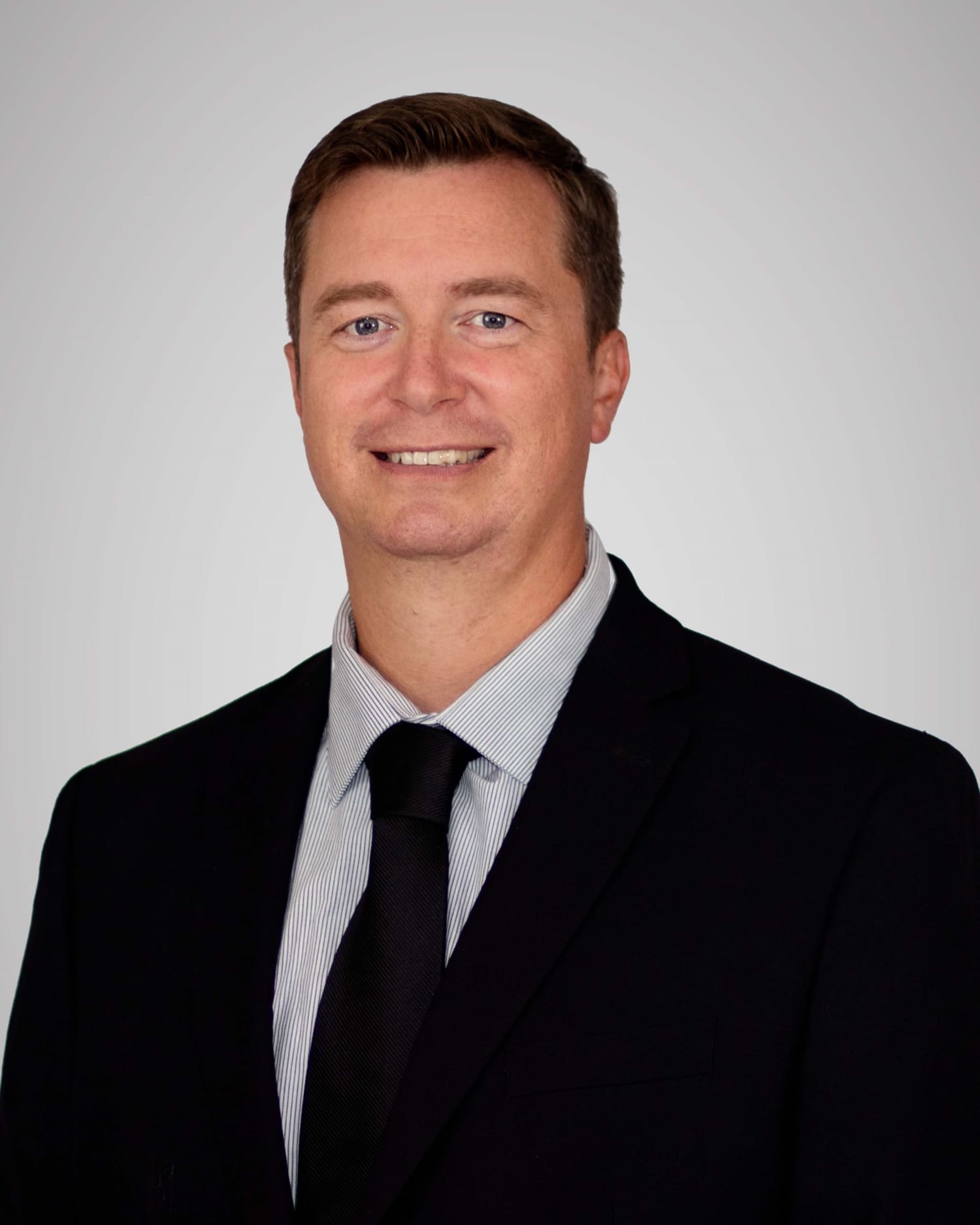 Man in suit and tie headshot, located at Virginia Gay Hospital