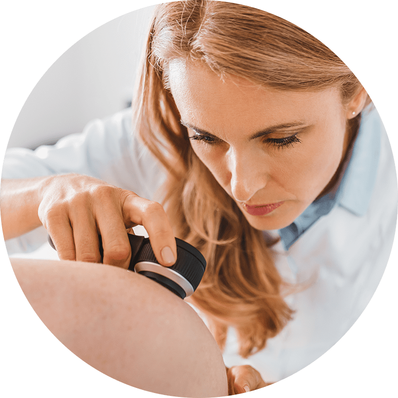 dermatology doctor looking at spot on skin