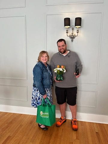 Daisy Award Honoree with flower bouquet