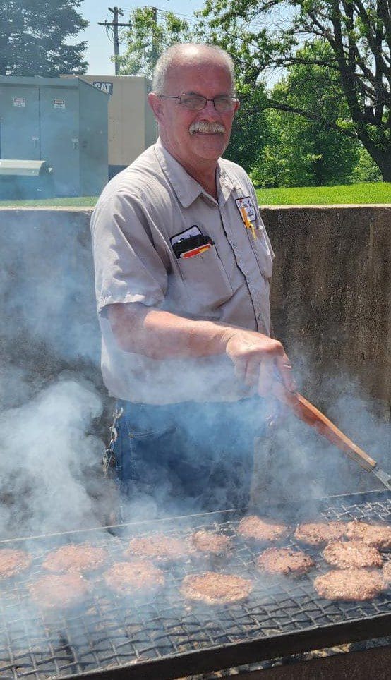 Rick Lazenby man grilling hamburgers