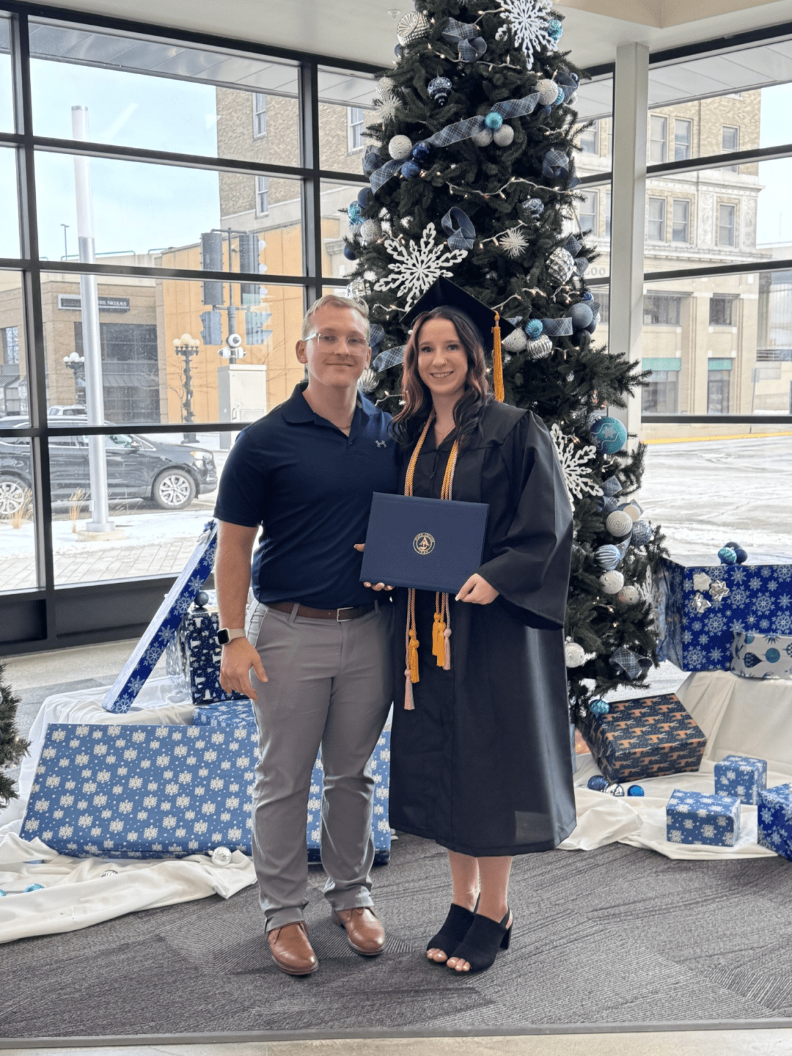 Andrew Dickson, man posing with woman who is graduate